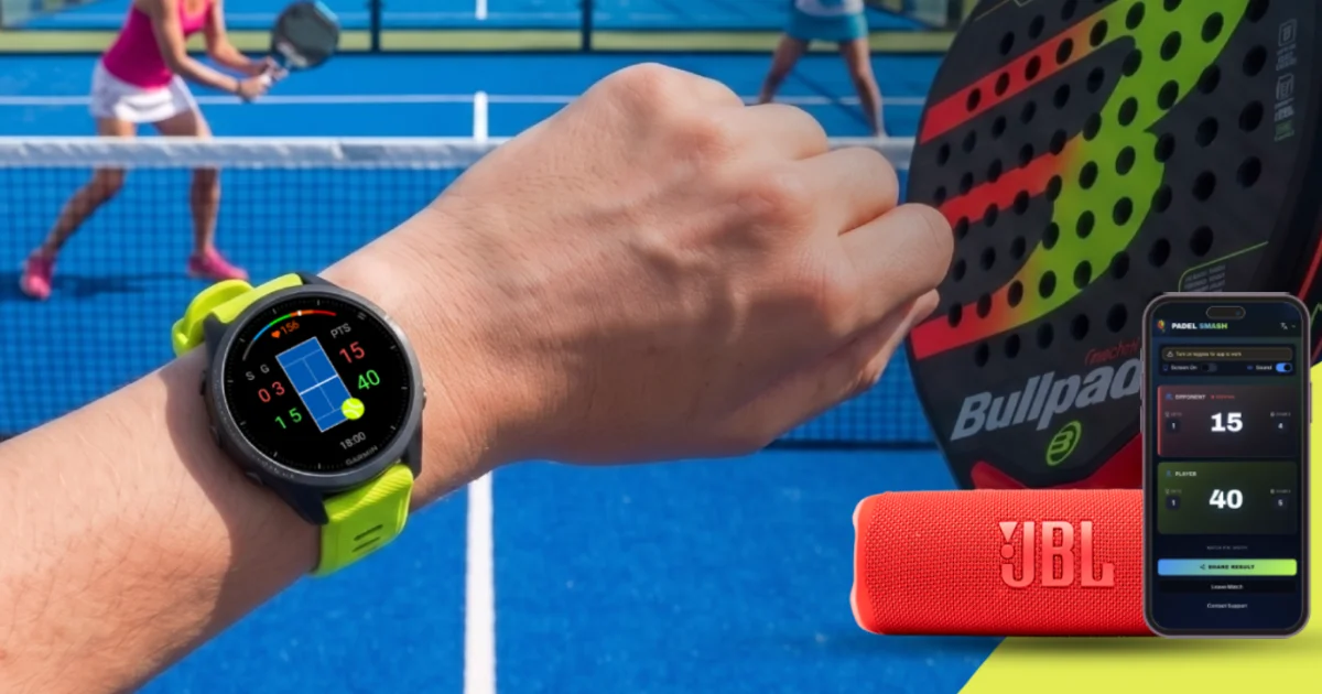 A Garmin watch running Padel Smash on a player's wrist at a padel court, with a phone showing the live scoreboard and a portable Bluetooth speaker beside a padel racket